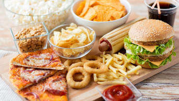 close up of fast food snacks and drink on table