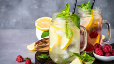 Lemonade. Two lemonades - classic and raspberry in mason jars. Close up.