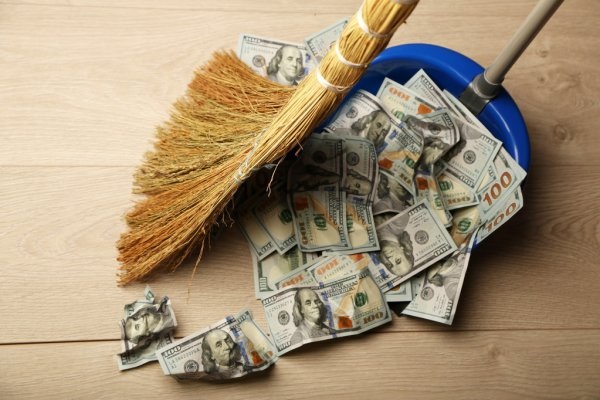 depositphotos_80214344-stock-photo-broom-sweeps-dollars-in-garbage